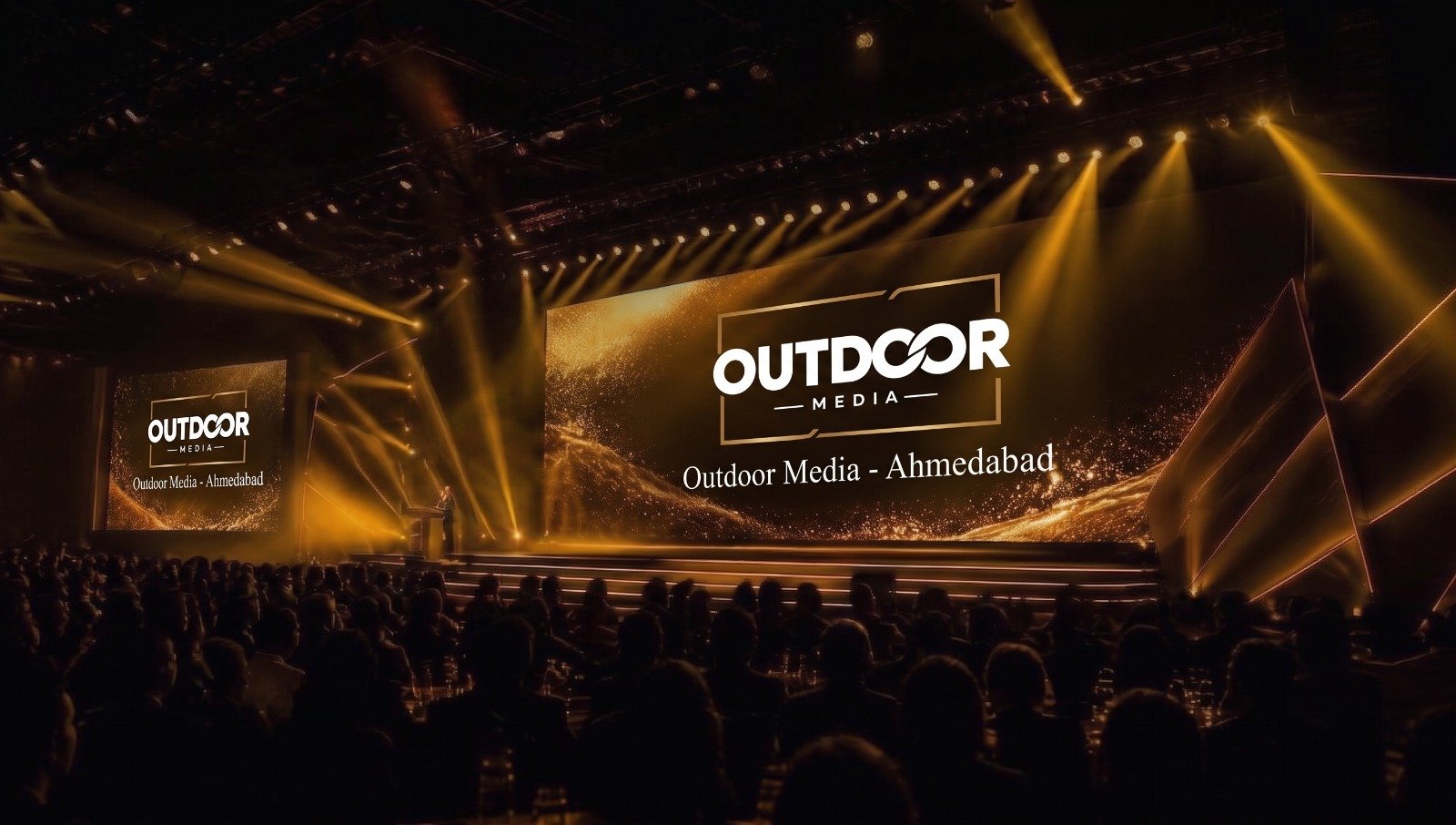Gold-lit corporate event stage with LED screens and an audience, produced by Outdoor Media